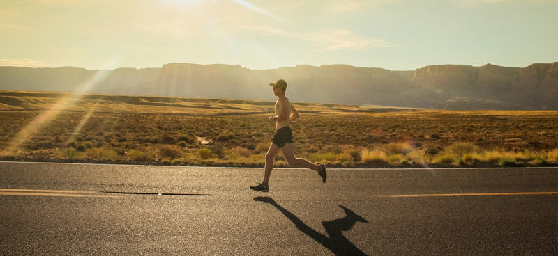 A runner pressing on along an open road