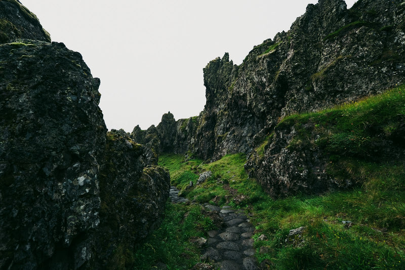 A stone path winding through a narrow gap between jagged rocks