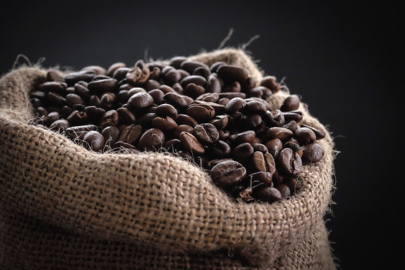 Green coffee beans being transformed by roasting