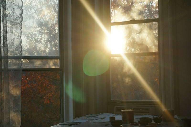 Morning sun shining through a window into a quiet room